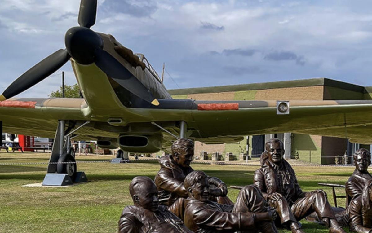 Outdoor display of plane and bronze airman