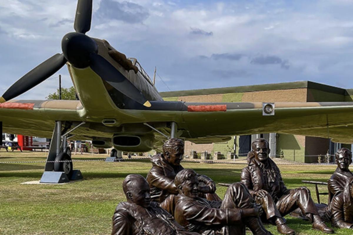 Outdoor display of plane and bronze airman 